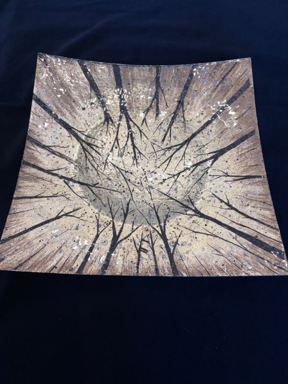 Decorative painted glass platter in gold, black, & white.
